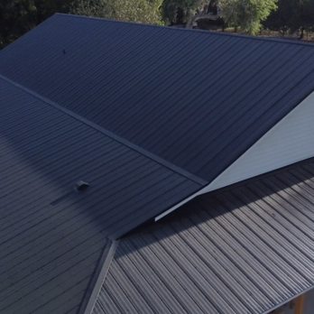 Tip Top Roofing - An aerial view of a new standing seam metal roof recently installed in Christmas Florida - Roofing Near Me - Orlando, Florida Tip Top Roofing - An aerial view of a new standing seam metal roof recently installed in Christmas Florida - Roofing Near Me - Orlando, Florida
