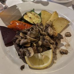 New York Steak cooked well done with mushrooms no gravy. Not what I was expecting "over cooked"