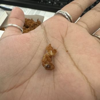 Chick-fil-A - ows a hand holding a piece of food - Fast Food Near Me - Baytown, Texas