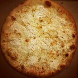 Moto Pizza - The Whitey pizza uses oregano-infused ricotta, fresh garlic, and silky mozzarella.