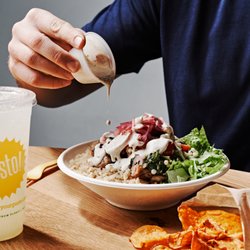 gusto! - Peachtree Rd - Our tzatziki lemon artichoke bowl is full of kalamata olives, cucumbers, artichoke, and grape tomato salad.  We garnish with pickled onions.