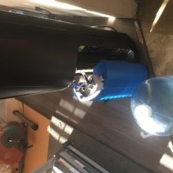The blue "tank" is attacked to the cooler. As you can see here the 5 gallon bottle does not fir the cooler nor are there hoses either.