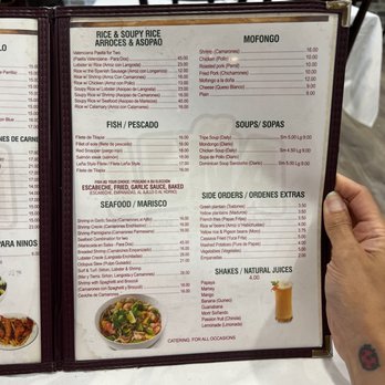 Lena Dominican Restaurant - a hand holding a menu - Spanish Near Me - Elmont, New York