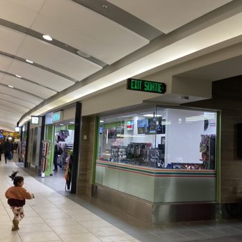 7-Eleven - a man and a child walking through a mall - Convenience Stores Near Me - Calgary, Alberta