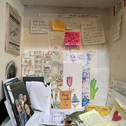a shelf with notes, notes, and pictures a shelf with notes, notes, and pictures