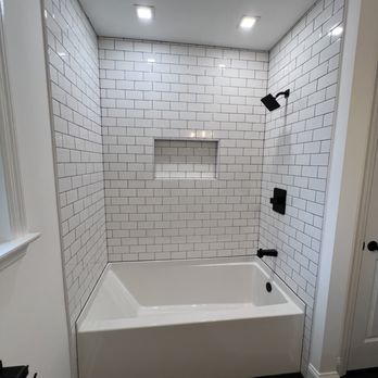 Shybella - a white tiled bathroom with a tub - Roofing Near Me Shybella - a white tiled bathroom with a tub - Roofing Near Me