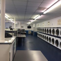 Super Wash Laundromat - Row of dryers on the right washers on the left, small medium and large.
