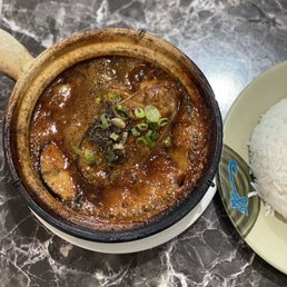 a bowl of stew and a plate of rice