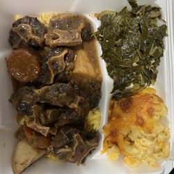 Uncle Gene's Soul And Seafood Cafe - Oxtails dinner with rice, sweet potato and regular potatoes, macaroni and cheese, and collard greens .