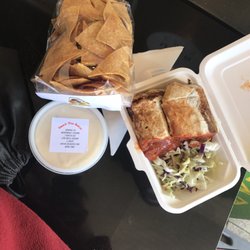 Taco Queen - Regular sized pork burrito with hot sauce. Really delicious pulled pork with add on refried beans. Chips and chile con queso on the side.