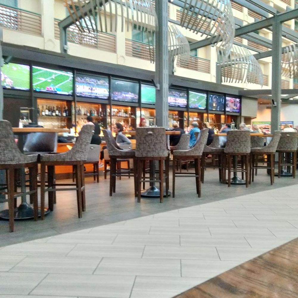 The bar is full. Nine screens playing sports and one screen with news.