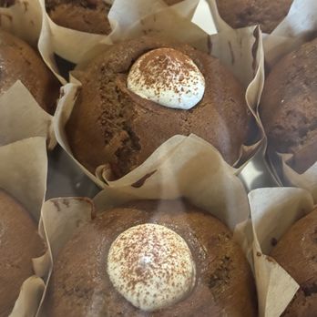 Theory Coffee Roasters - Pumpkin Cream Cheese Muffin - Chocolate muffins with a dollop of whipped cream and a dusting of cocoa powder on top, arranged in paper liners. - Coffee & Tea Near Me - Redding, California