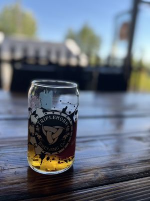 Photo of Triplehorn Brewing - Woodinville, WA, US. a glass of beer on a wooden table