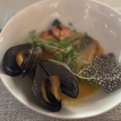 Air Canada Signature Suite - Ontario Pickerel in red curry sauce honey mussels, crab claw, squid ink tapioca cracker
