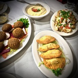 CLOCKWISE: Falafel (with tahini, $9), hummus (with pita, $7), arnabeet (roasted cauliflower, $8), Sambousek ($8) CLOCKWISE: Falafel (with tahini, $9), hummus (with pita, $7), arnabeet (roasted cauliflower, $8), Sambousek ($8)