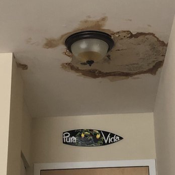 Beal Properties - The main leak at is worst - yes, that is a brand new light fixture filling with brown rainwater! Definitely not a fire hazard. - Property Management Near Me - Chicago, Illinois