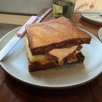 True Laurel - GRILLED CHEESE AND OMELETTE SANDWICH 2.0: Sausage Patty, Omelette, Cheese, Tomato Mayo on Toasted Pain de Mie - Cocktail Bars Near Me - San Francisco, California True Laurel - GRILLED CHEESE AND OMELETTE SANDWICH 2.0: Sausage Patty, Omelette, Cheese, Tomato Mayo on Toasted Pain de Mie - Cocktail Bars Near Me - San Francisco, California