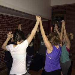 Laura Solly Yoga - Family Yoga in tree pose working together.