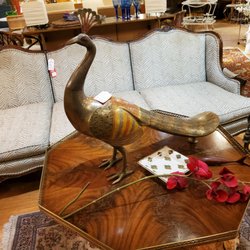 Creek Mercantile - A brass peacock looking out over his domain