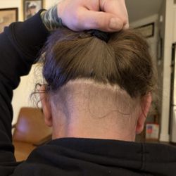 Tait's Barbershop - A tape up that was done with a hedge trimmers.
