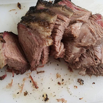 BBQ at Frankie's - a piece of meat on a cutting board - Barbeque Near Me - Austin, Texas