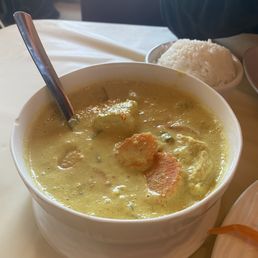 Chicken curry with a bowl of rice