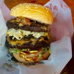 Eat Sleep Burger - Triple Quarter Pounder with bacon, mushroom, cheese, and egg, with belgian fries on the side, and iced tea served in a mason jar.