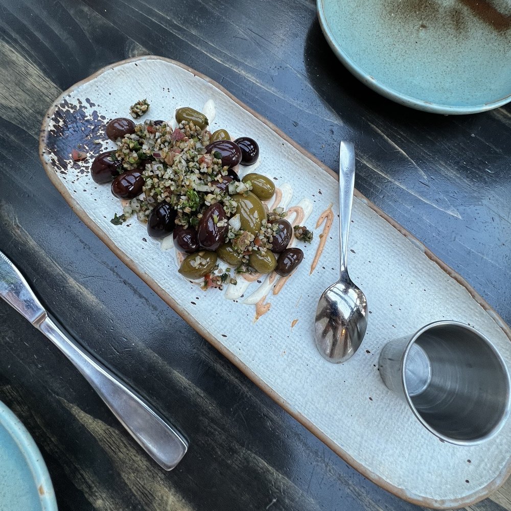 Porch - Marinated Olives with Harissa Lebnah - Comfort Food Near Me - Calgary, Alberta Porch - Marinated Olives with Harissa Lebnah - Comfort Food Near Me - Calgary, Alberta
