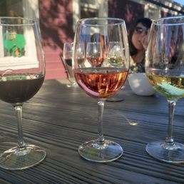 three glasses of wine on a table three glasses of wine on a table