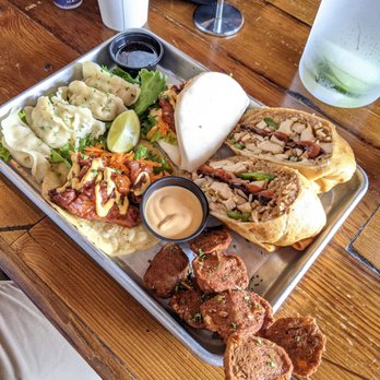 Cris and John - One of their $25 trays with a Phorito, steam buns, dumplings and chicken skewers - Vietnamese Near Me - Dallas, Texas
