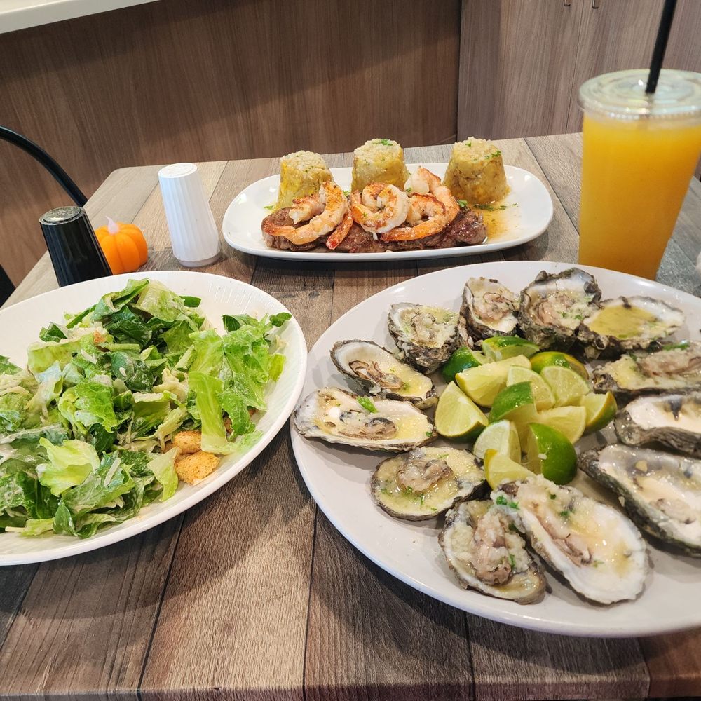 Oysters, Ceasar salad and surf and turf steak mofongo. Oysters, Ceasar salad and surf and turf steak mofongo.