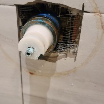 JG Tile - a hole in the wall of a bathroom - Handyman Near Me