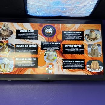 Vampire Penguin - A digital menu screen at Vampire Penguin shows different snow cone flavors with descriptions, including cookies & cream snow, vanilla snow, and chocolate snow. - Shaved Snow Near Me - Hurst, Texas