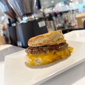 Sweetwaters Coffee & Tea - Biscuit Sandwich - Sausage & Cheese. Can order to go or plenty of seating in the coffee shop, including one table that sits about 8. - Coffee & Tea Near Me - Grand Forks, North Dakota Sweetwaters Coffee & Tea - Biscuit Sandwich - Sausage & Cheese. Can order to go or plenty of seating in the coffee shop, including one table that sits about 8. - Coffee & Tea Near Me - Grand Forks, North Dakota