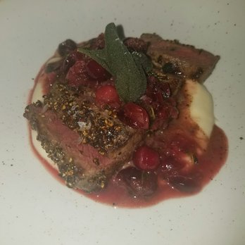 FlintCreek Cattle - Bad light, good food. Venison with brandy cranberry gastrique and parsnip puree - New American Near Me - Seattle, Washington