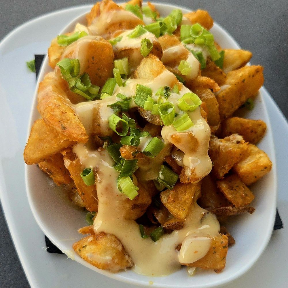 Lavender Rooftop Kitchen & Bar - Crispy potatoes (smoked paprika, roasted garlic aioli and cheese) - Wine Bars Near Me - Savannah, Georgia