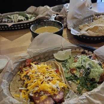 Torchy's Tacos - BF's taco, burrito behind chips, queso, Republican taco on left, and Mr. Orange taco - Tex-Mex Near Me - Greenwood, Colorado