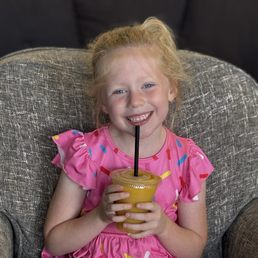 My daughter with a mango-pineapple-banana smoothie. My daughter with a mango-pineapple-banana smoothie.