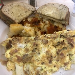 Meat lovers omelette- ham, bacon, sausage, cheese - nice breakfast. Meat lovers omelette- ham, bacon, sausage, cheese - nice breakfast.