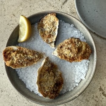 Manuela - Barbecued Oysters, Green Garlic Butter, Preserved Lemon Breadcrumbs, Parmesan - New American Near Me - Los Angeles, California Manuela - Barbecued Oysters, Green Garlic Butter, Preserved Lemon Breadcrumbs, Parmesan - New American Near Me - Los Angeles, California