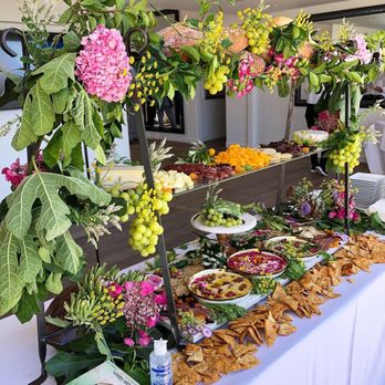 Bites & Bashes Catering - Our signature antipasto and cheese station, with beautiful produce and foliage from our family farm - Caterers Near Me Bites & Bashes Catering - Our signature antipasto and cheese station, with beautiful produce and foliage from our family farm - Caterers Near Me