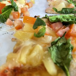 Pineapple, spinach, tomato pizza