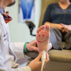Eugene Foot and Ankle - Dr. McCourt using the diagnostic ultrasound for heel pain, aka plantar fasciitis in this scenario.