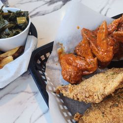 Hot lemon pepper wings, fried red snapper, fries and greens