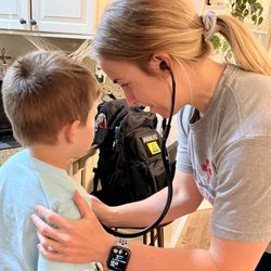 Table Rock Mobile Medicine - Jessica taking the time to do a good physical exam on a child who is more comfortable and cooperative in their home vs a clinic