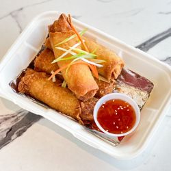 Arkanseoul - Crispy chicken and veggie egg rolls served with side of sweet chili sauce