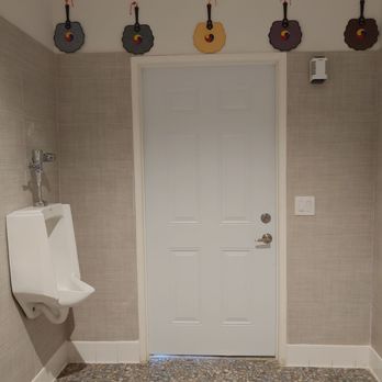 Hygge Coffee - Upon exiting the bathroom, there is a urinal and more Korean fans along the top. - Coffee & Tea Near Me - La Mirada, California