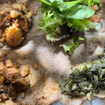 Demera - Messob for 1...off menu (lamb alicha sauce, fish tibs, collards and spinach) salad is comp. - Ethiopian Near Me - Chicago, Illinois Demera - Messob for 1...off menu (lamb alicha sauce, fish tibs, collards and spinach) salad is comp. - Ethiopian Near Me - Chicago, Illinois