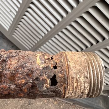 Service Experts - Corroded 2 inch black iron natural gas pipe full of holes going from gas meter thru sleeve in house wall into crawl space - Heating & Air Conditioning/HVAC Near Me - Knoxville, Tennessee Service Experts - Corroded 2 inch black iron natural gas pipe full of holes going from gas meter thru sleeve in house wall into crawl space - Heating & Air Conditioning/HVAC Near Me - Knoxville, Tennessee