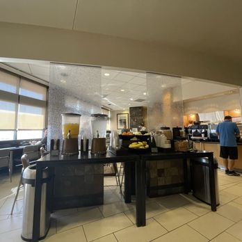 Admirals Club - A20 - Food table with bar in the far background. - Airport Lounges Near Me - Phoenix, Arizona Admirals Club - A20 - Food table with bar in the far background. - Airport Lounges Near Me - Phoenix, Arizona